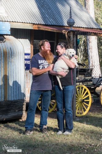 Samara and Robert Hill sharing a candid moment with a Filigrigold Golden Retriever puppy.